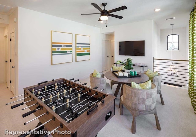 interior space with ceiling fan and light carpet