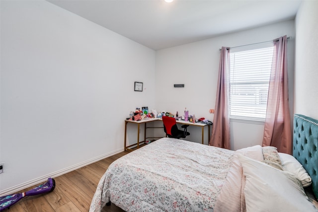 bedroom with hardwood / wood-style flooring