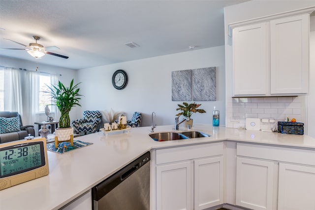 kitchen featuring dishwasher, white cabinets, sink, decorative backsplash, and kitchen peninsula