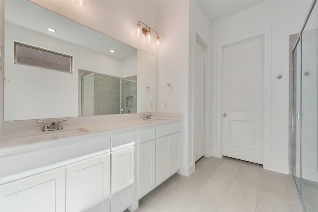 bathroom featuring tile patterned floors, vanity, and an enclosed shower