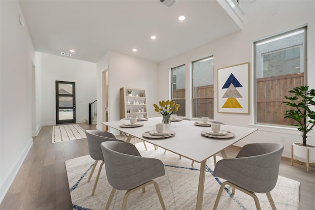 dining space with light hardwood / wood-style flooring