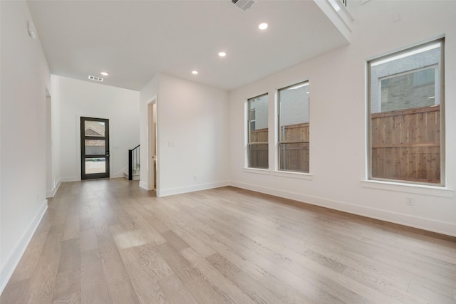 unfurnished living room with light hardwood / wood-style flooring