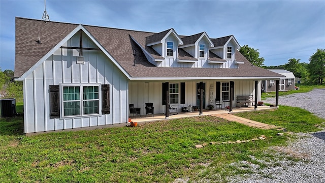 view of front of house featuring central air condition unit, a patio, and a front yard