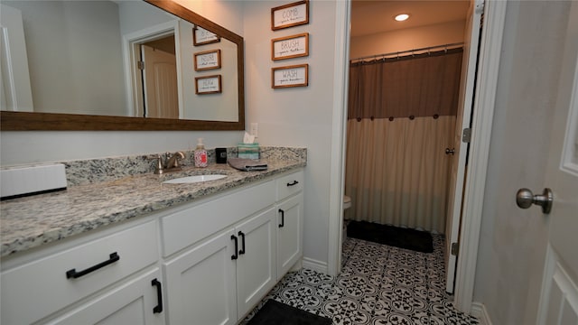 bathroom with tile patterned floors, vanity, toilet, and a shower with curtain