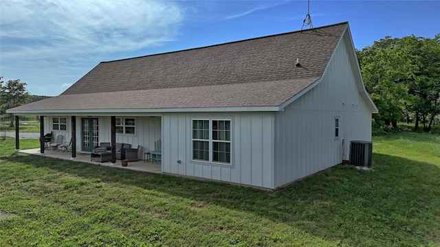 back of house featuring outdoor lounge area, a patio area, central air condition unit, and a lawn