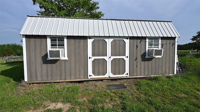 view of outdoor structure with a yard and cooling unit