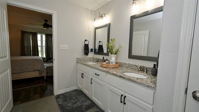 bathroom featuring ceiling fan, hardwood / wood-style floors, and vanity