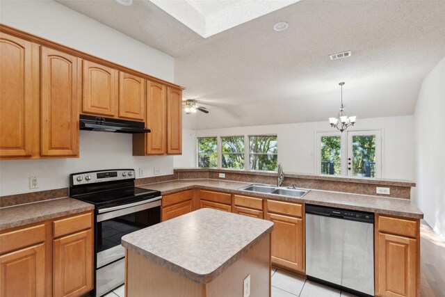 kitchen with stainless steel appliances, a kitchen island, lofted ceiling, and sink