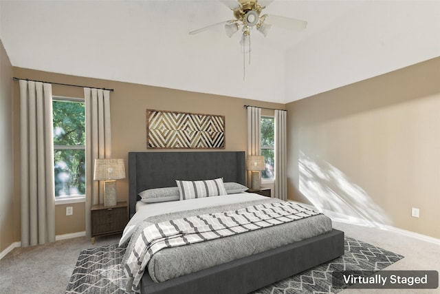 bedroom with ceiling fan, carpet floors, and multiple windows