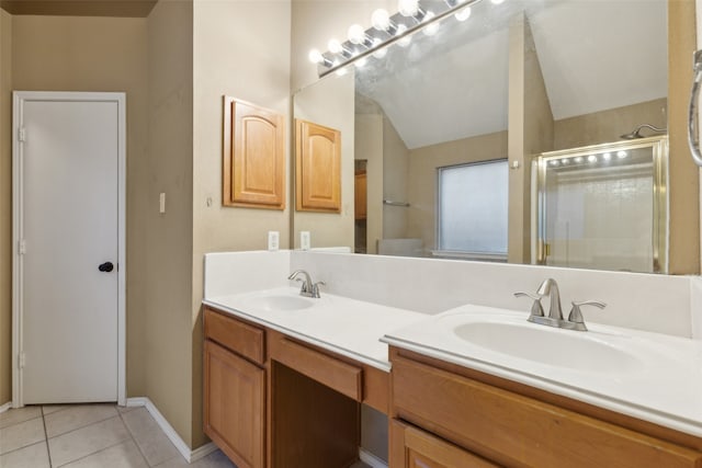 bathroom with tile patterned flooring, vanity, and walk in shower