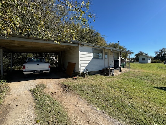 view of front of property featuring a carport, covered porch, and a front lawn