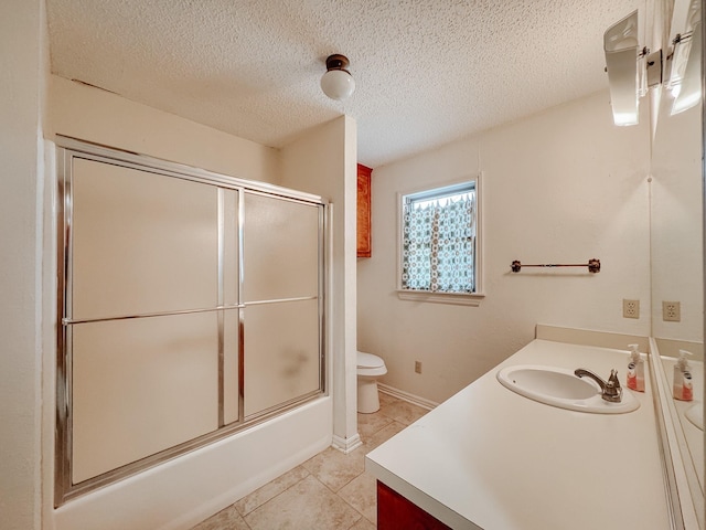 full bathroom featuring tile patterned floors, toilet, vanity, and combined bath / shower with glass door