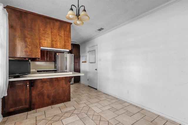 kitchen featuring a textured ceiling, decorative light fixtures, kitchen peninsula, stainless steel refrigerator, and a chandelier