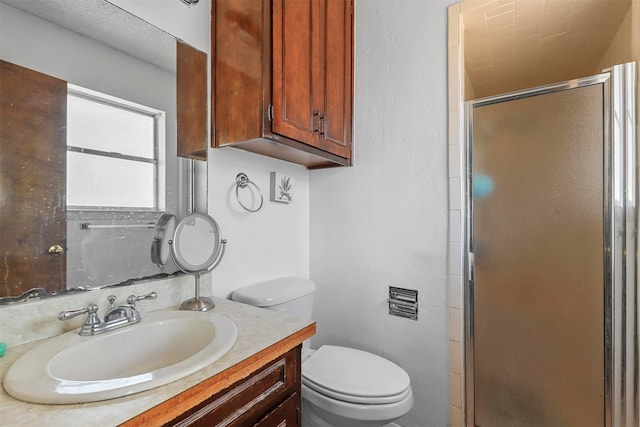 bathroom featuring vanity, toilet, and an enclosed shower