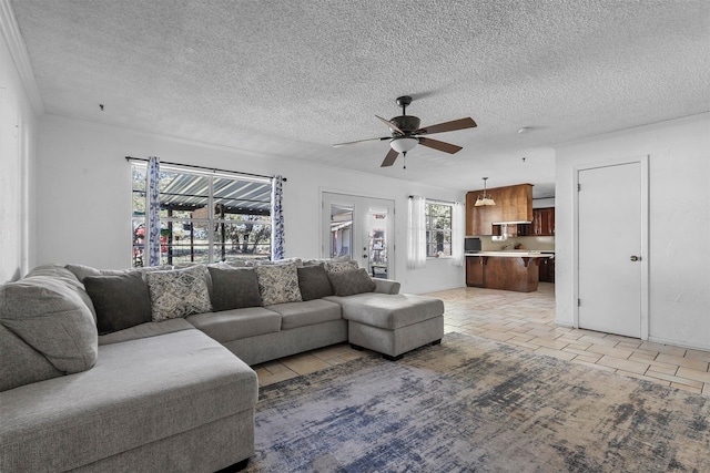 tiled living room with ceiling fan and a textured ceiling