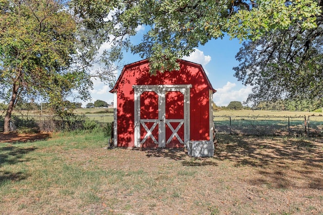 view of outbuilding with a yard and a rural view