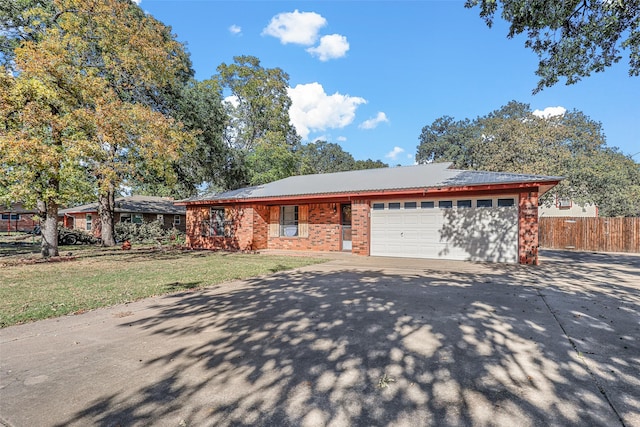 single story home with a garage and a front yard