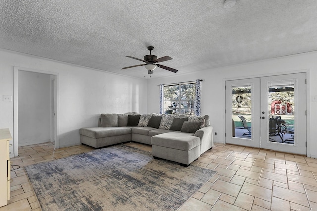 living room with a textured ceiling, ceiling fan, plenty of natural light, and french doors