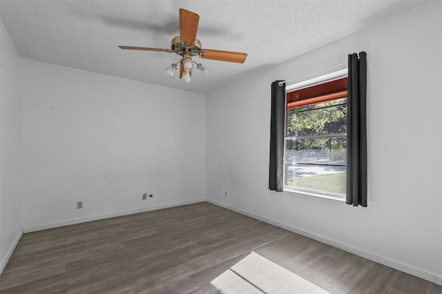 empty room with ceiling fan, a textured ceiling, and hardwood / wood-style flooring