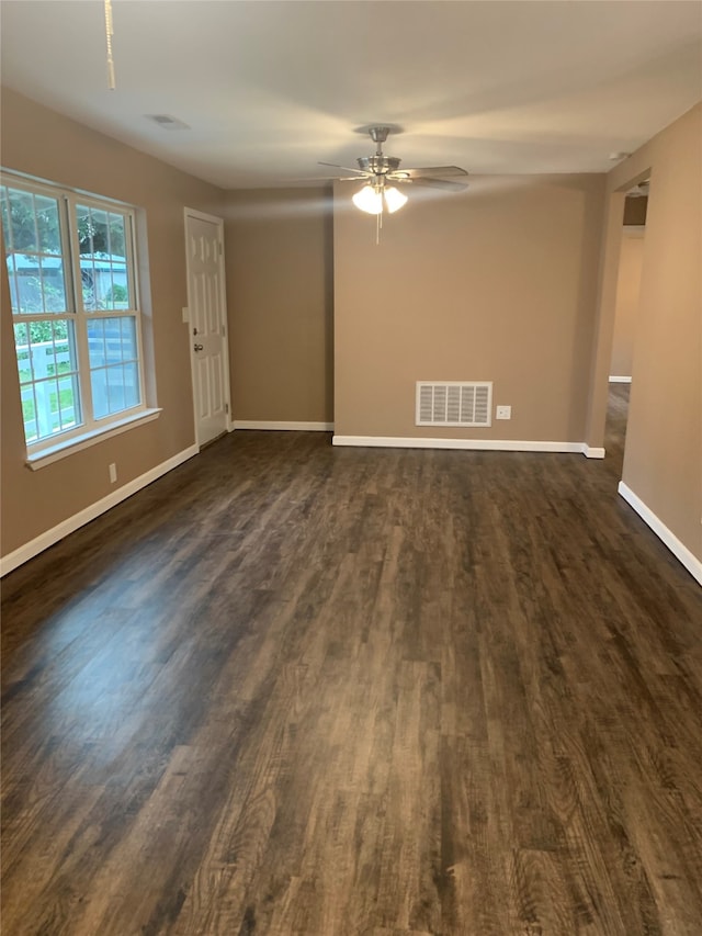 empty room featuring ceiling fan and dark wood-type flooring