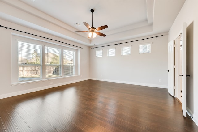 spare room with dark hardwood / wood-style floors, plenty of natural light, and ceiling fan