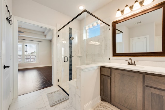 bathroom featuring hardwood / wood-style floors, vanity, and a shower with door