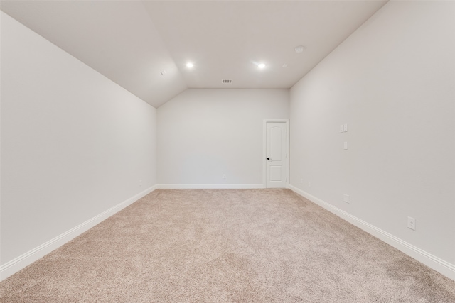 empty room featuring lofted ceiling and carpet floors