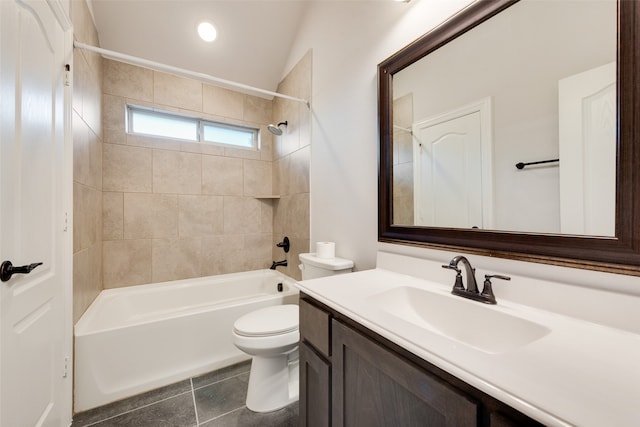 full bathroom with vanity, lofted ceiling, tiled shower / bath, tile patterned flooring, and toilet