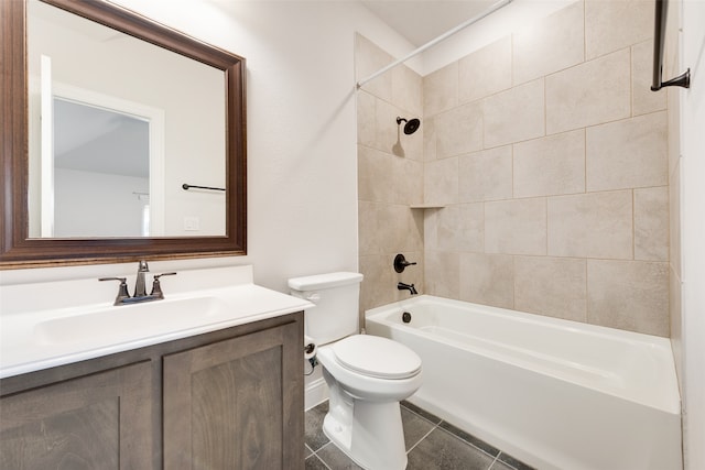 full bathroom with tile patterned flooring, toilet, vanity, and tiled shower / bath