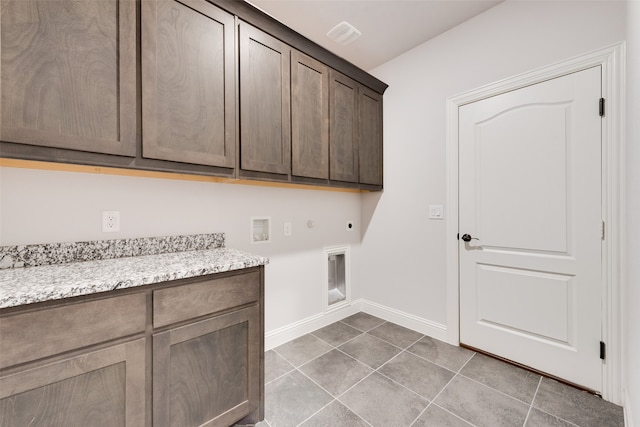 washroom featuring cabinets, washer hookup, tile patterned floors, gas dryer hookup, and electric dryer hookup