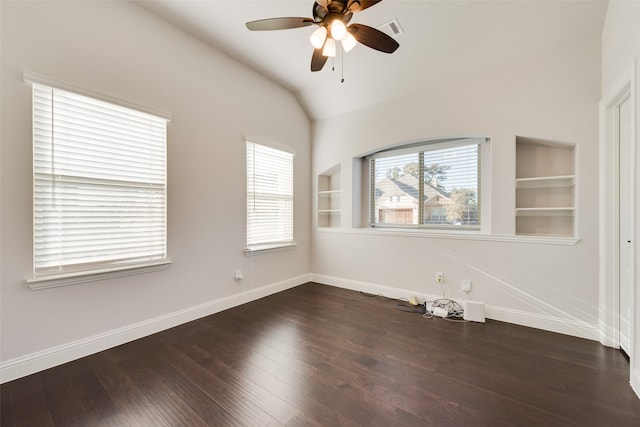 unfurnished room with built in shelves, ceiling fan, dark hardwood / wood-style flooring, and vaulted ceiling