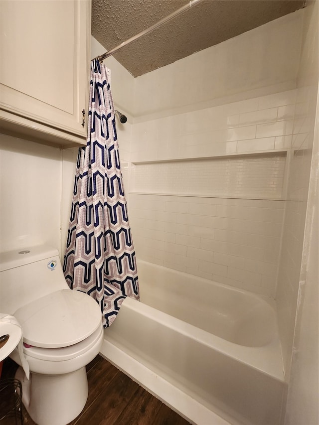 bathroom with hardwood / wood-style flooring, toilet, shower / bathtub combination with curtain, and a textured ceiling