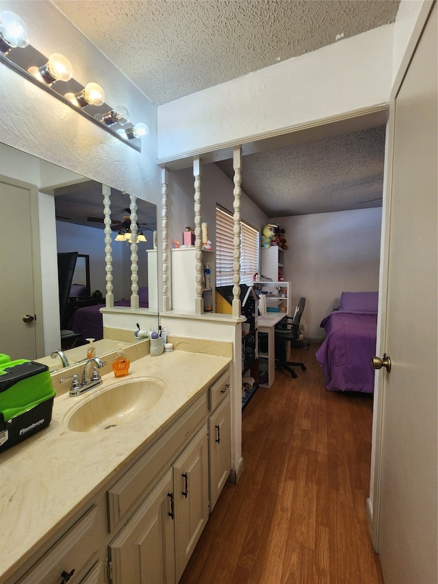 bathroom featuring hardwood / wood-style floors, vanity, and a textured ceiling