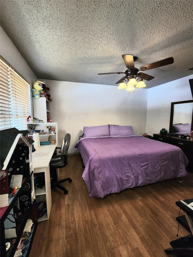 bedroom featuring ceiling fan, dark hardwood / wood-style floors, and a textured ceiling