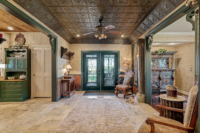 entryway featuring french doors, ceiling fan, and ornamental molding