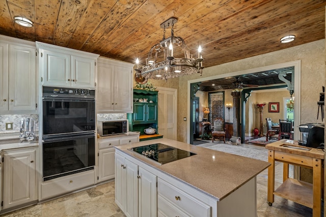 kitchen featuring white cabinetry, hanging light fixtures, wooden ceiling, and black appliances