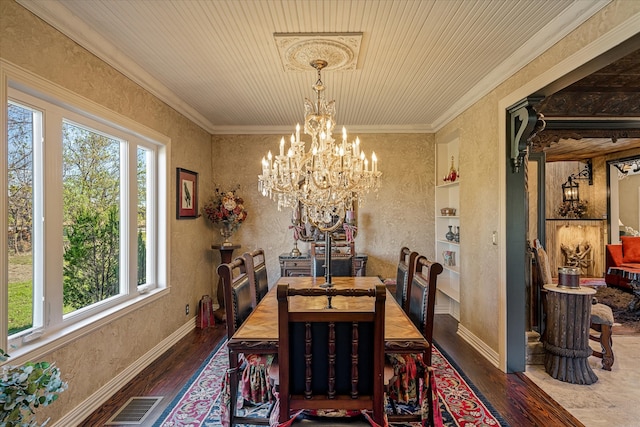 dining area featuring dark hardwood / wood-style flooring, crown molding, and a healthy amount of sunlight