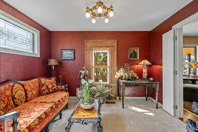 interior space featuring a notable chandelier, a healthy amount of sunlight, and light carpet