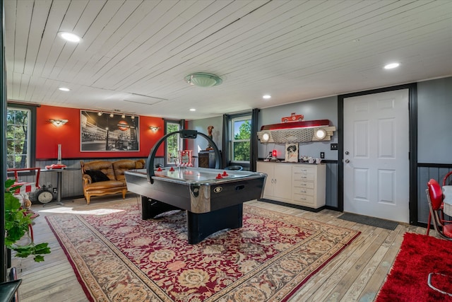 recreation room featuring light hardwood / wood-style floors, wood ceiling, and a wealth of natural light