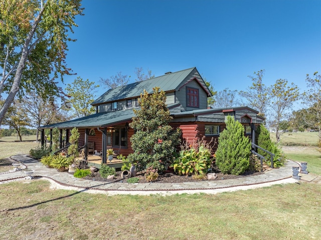 exterior space featuring a porch and a yard