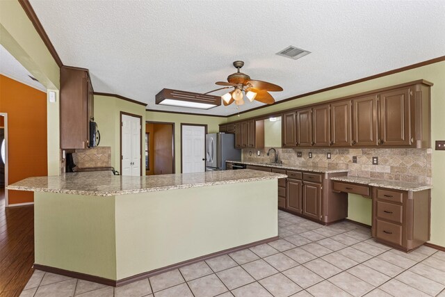 unfurnished dining area with light tile patterned floors, a chandelier, and crown molding