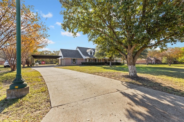 new england style home featuring a carport and a front yard