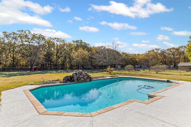 outdoor pool with a patio area, a fenced backyard, and a yard