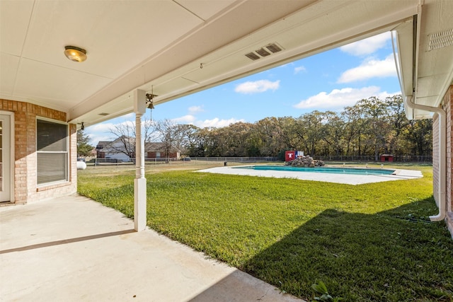 view of yard featuring a patio area, fence, and a fenced in pool