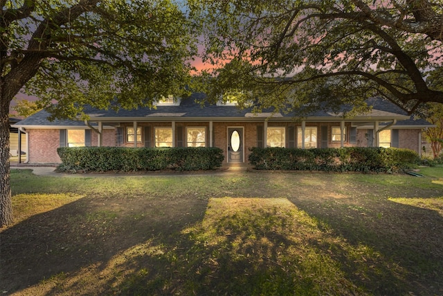 ranch-style house with brick siding and a front lawn