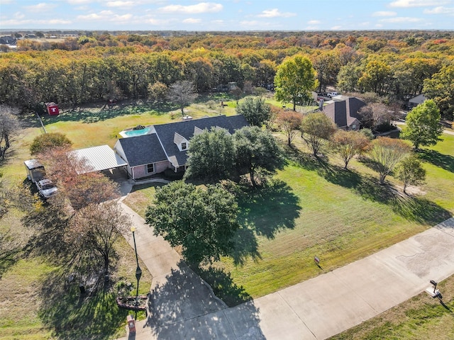 drone / aerial view featuring a forest view