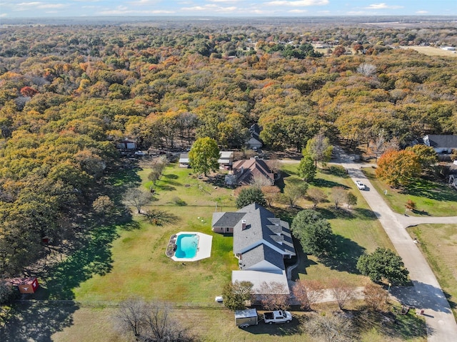 drone / aerial view featuring a wooded view