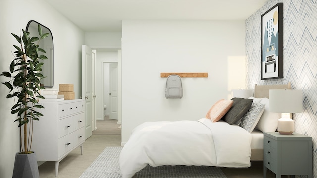 bedroom featuring connected bathroom and light colored carpet