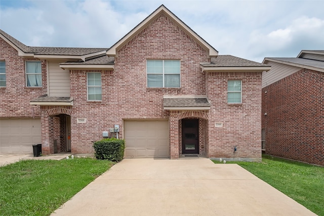 view of front of home with a front lawn and a garage