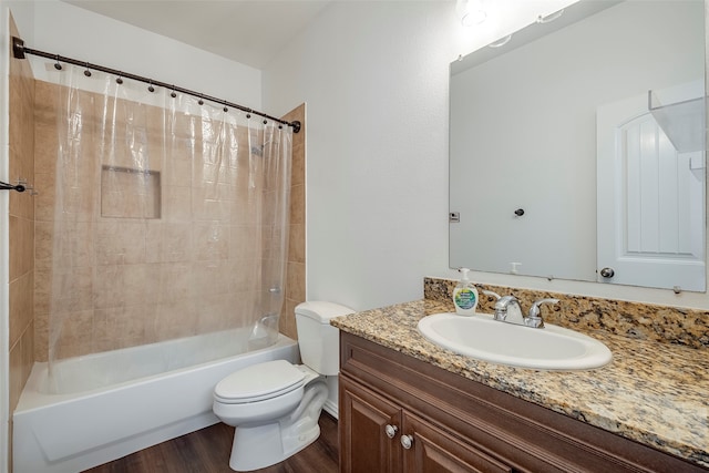 full bathroom with wood-type flooring, vanity, shower / tub combo, and toilet